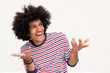 © mimagephotos - smiling cool North African guy with hands raised and wondering expression