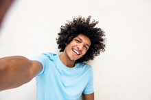Happy Young North African Man Taking Selfie Against White Background