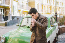 Portrait Of A Model Young Handsome Sexy Male Brunette Guy With Dark Skin Turkish Middle Eastern Brunette Posing Smoking A Cigarette Near Old Retro Car On The Street