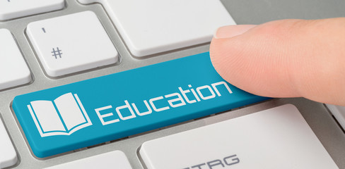 Wall Mural - a keyboard with a blue labeled button - education