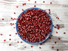  Close-up Of Pomegranate Seeds, Burgundy, In A Large Blue Plate