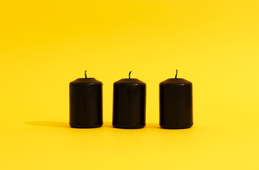 black candles on a yellow background