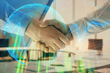 Wall Mural - Multi exposure of financial chart and map on office background with two businessmen handshake. Concept of success in business