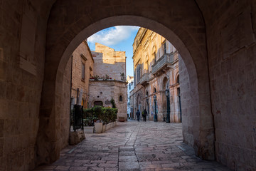 Canvas Print - Evening winter on the streets of Polignano a Mare Old Town with Arco Marchesale, Bari Province, Puglia region, southern Italy.