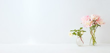 Home Interior With Decor Elements. Pink Peonies In A Vase And White Flowers On A White Background
