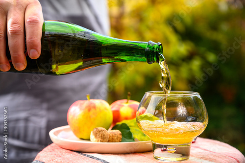 Cuadros en Lienzo Tasting of french apple cider made from new harvest apples outdoor in orchard