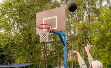 A Black Ball Is Flying In The Basket.