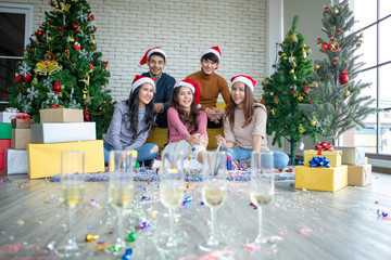 Wall Mural - Friends celebrating Christmas or New Year eve party with champagne