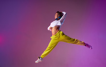 Charming Young Lady Jumping High Making Acrobatics Movies In The Air, Performing Dancing Skills, Isolated On Bright Coloured Background, Urban Lifestyle Concept