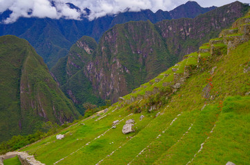 Machu Picchu, legendary Inka capital Peruvian Andes. Historic and ancient ruins and stonewalls high in the mountains. UNESCO world cultural heritage, new wonder of the world and tourist destination