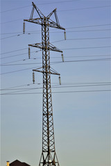 high voltage tower wires against the sky