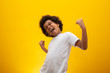 African American boy with black power hair on yellow background. Smiling black kid with a black power hair. Black boy with a black power hair. African descent.