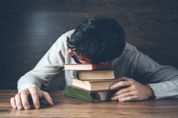 Sticker - sad man head on book on desk