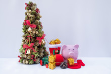 Piggy Bank And Beautifully Decorated Christmas Tree With A Holiday Party Beginning In The New Year And Crossing To Year 2020