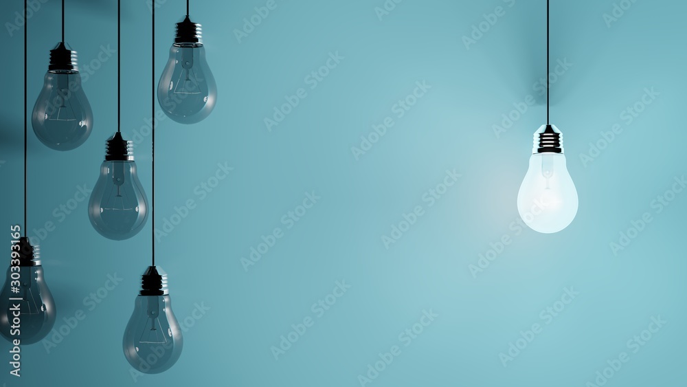 Hanging light bulbs on blue background with one illuminated and space for text - obrazy, fototapety, plakaty 