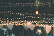 Old light bulb decor in outdoor party, vintage filter