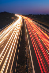 Busy highway with fast moving vehicles in beautiful sunset