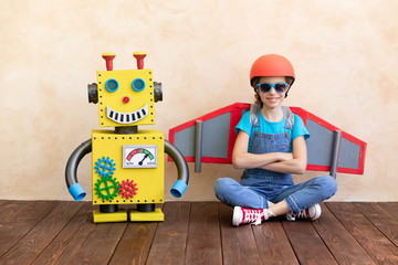 Canvas Print - Happy child with toy robot