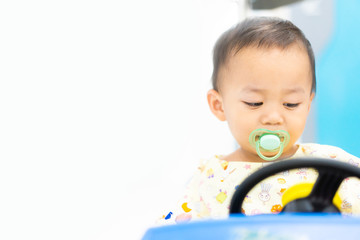 Poster - Sick child baby boy driving toy car with a fever at hospital