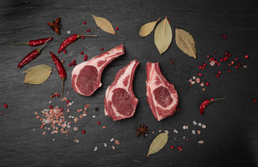 Wall Mural - Raw Lamb Chops, Mutton Cuts or Sheep Ribs on Black