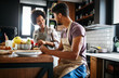 Happy couple preparing healthy food in kitchen