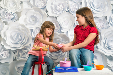 happy little girl sits in front of children's toys