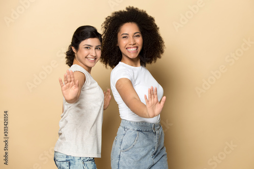 Fotografía Smiling beautiful diverse girls dancing, standing with arms outstretched