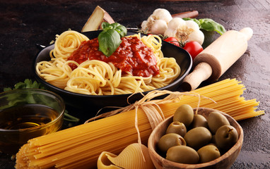 Tasty appetizing classic italian spaghetti pasta with tomato sauce, cheese parmesan and basil and ingredients