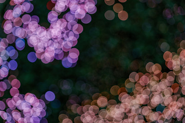 Wall Mural - Illuminated abstract round red, purple, blue, green and magenta bokeh on dark background. Colourful glitter bokeh from out of focus view of decoration bulbs.