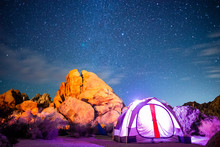 Illuminated Tent Next To Sandstone Beneath Starry Night Sky - Wide Angle