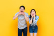 © Atstock Productions - Young lovely asian couple yelling with hands cup around mouths