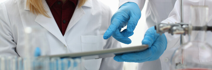 A male doctor in a chemical laboratory holds