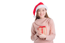 Beautiful Asian Girl Wearing Santa Claus Hat Holding Christmas Gift Box And Smiles Isolated Over White Background.