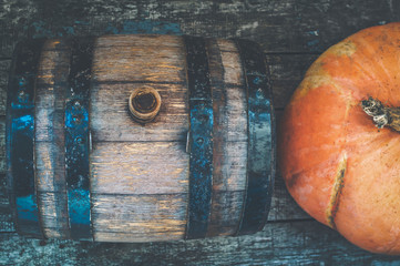 Beautiful wooden barrel and pumpkins on a wooden table. Top view. vintage processing with camera noises, film grain.