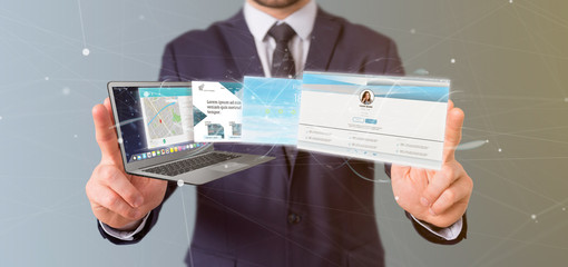 Poster - Businessman holding a Website application going out a laptop screen 3d rendering