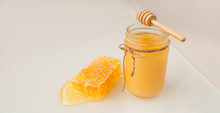 Honey Dipper And Jar Of Creamed Amber Organic Honey Bee Harvest Next To Fresh Honeycomb Healthy Food Banner Panorama.