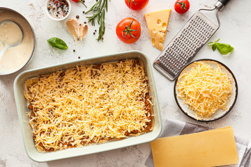 Cooking of tasty lasagna on white background