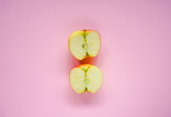 Two apple slices on pink background, flat lay, minimalism, top view, creative concept