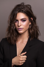 Portrait Of Young Beautiful Brunette Model With Violet Professional Make Up, Trendy Wavy Hairdo And Perfect Skin.