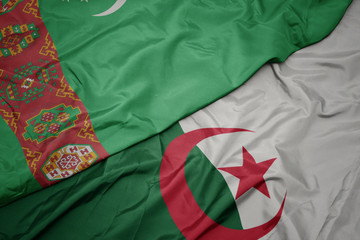 waving colorful flag of algeria and national flag of turkmenistan.