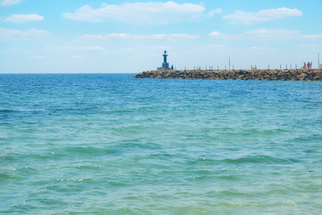 Wall Mural - Cloudy sky and breakwater in the sea against a cloudy sky