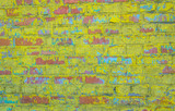 Fototapeta Dinusie - Old weathered brick wall. Peeling cracked paint on red brick