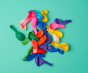 Aufkleber - many deflated latex colorful balloons scattered on a green background