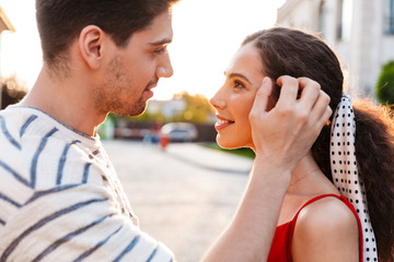 Wall Mural - Image closeup of happy young couple smiling and looking at each other