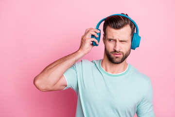 Sticker - What is it. Frustarted music lover man disdlike his playlist song he listen from blue modern headset feel confused expression wear casual style clothes isolated over pink color background