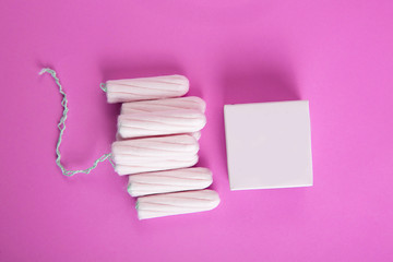 Wall Mural - Medical female tampon on a pink background.