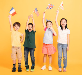 Wall Mural - Group of happy kids showing the flags