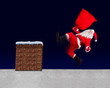 The unhappy Santa Claus slipped with bag on a snowy roof with the chimney. Santa Claus accident while distributing a gift. The Christmas disaster on a roof.