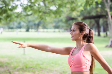 Young woman practicing yoga in the park.female happiness.