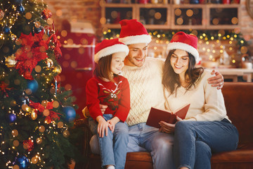 Adorable festive family reading xmas fairy tales together